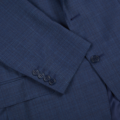 Close-up of the Canali Mid Blue Micro Design Wool Suit. Focus on the sleeve shows four dark cuff buttons and one body button, highlighting elegant formalwear with fine textured wool fabric and subtle light blue threading. , available at Richard Gelding Mayfair