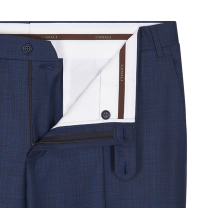 A close-up of the Canali Mid Blue Micro Design Wool Suit pants, partially unbuttoned and unzipped to reveal the white inner waistband with CANALI branding and dark blue buttons. A subtle micro design pattern completes this men's formalwear piece. , available at Richard Gelding Mayfair