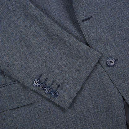 Close-up of a Canali Blue Texture Design Wool Suit sleeve, showing four dark cuff buttons and part of a matching body button. The fabric is smooth, finely woven, and features a subtle textured design. , available at Richard Gelding Mayfair