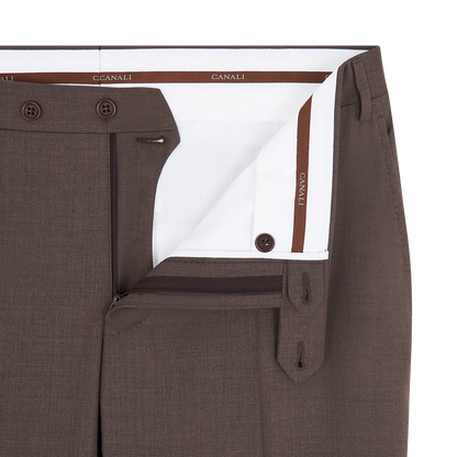 Close-up of Canali Dark Brown Tropical Wool Suit pants with unbuttoned waistband, partially open zipper showing white inner lining with brown trim and branding. Features include belt loops, double buttons, and finely textured fabric. , available at Richard Gelding Mayfair