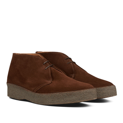 A pair of Polo Snuff Suede Hi Top Boots by Sanders with laces and a rubber crepe sole on a transparent background.