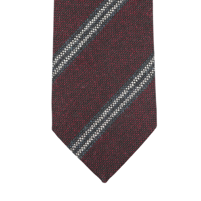 Handmade in England by Seaward & Stearn, the Burgundy Blue Striped Wool Tie showcases an elegant close-up of its diagonal blue and white stripes.