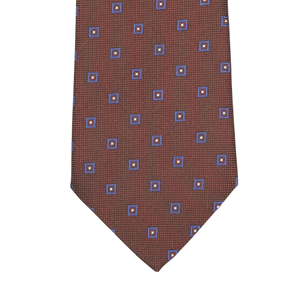Close-up of Seaward & Stearnâ€™s Cinnamon Brown Geometric Printed Silk Tie, featuring a stunning pattern of blue and orange squares and beautifully crafted by hand.