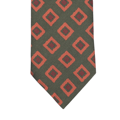 A Seaward & Stearn tie, known as the Green Orange Geometric Silk Tie, features a rich green background decorated with elegantly crafted red diamond shapes and intricate black geometric designs.