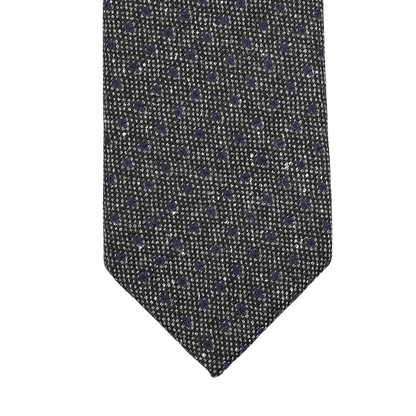 Close-up of the Seaward & Stearn Grey Blue Dot Wool Tie, highlighting its pure wool craftsmanship and subtle polka dot pattern against a white background, all handmade in England.