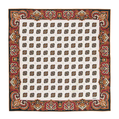 The Bucaneve White Silk Pocket Square from Sera Fine Silk is a square textile with a white background, featuring a pattern of brown and gold geometric shapes, and bordered with an ornate red floral design.