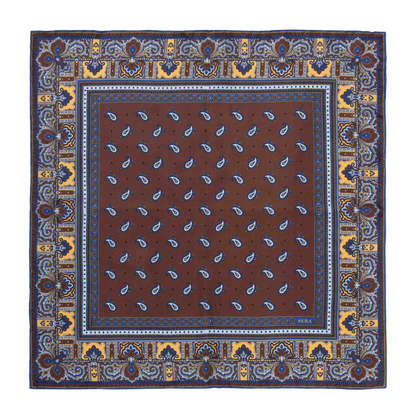 The Chocolate Recioto Silk Pocket Square by Sera Fine Silk is a square, brown paisley-patterned luxury silk pocket square, featuring intricate blue and yellow border detailing, made in Italy.