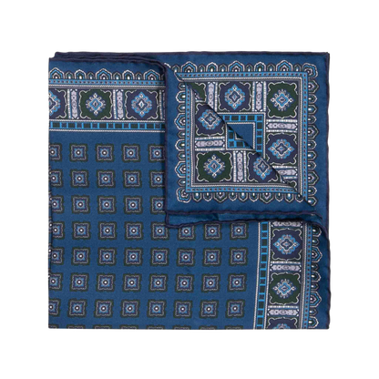 The Salt Primitivo Silk Pocket Square by Sera Fine Silk features intricate geometric patterns in shades of blue, green, and white, crafted from fine Como silk.