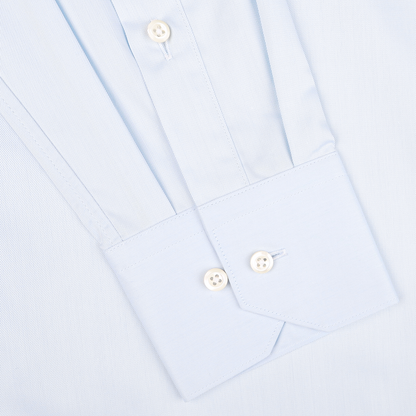 Close-up of a Light Blue Cotton Twill Fitted Body Shirt sleeve by Stenströms, featuring white buttons and a subtle vertical stripe pattern. Made from pure cotton twill, this shirt offers a fitted body cut for an elegant silhouette.