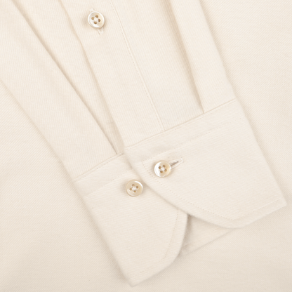 Close-up of a cuff from the Stenströms Cream Cotton Flannel Slimline BD Shirt, featuring four white buttons and made from a light brushed cotton twill fabric.