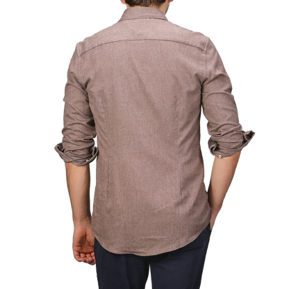 A person wearing the Brown Cotton Flannel Cut-Away Slimline Shirt by Stenströms and dark pants is seen from the back.