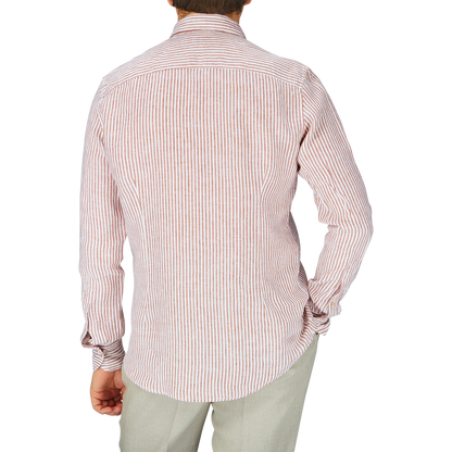 The man is wearing a Stenströms Dark Orange Striped Linen Slimline Shirt.