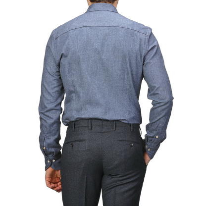 A person is shown from the back wearing a Stenströms Denim Blue Cotton Flannel Cut-Away Slimline Shirt and dark gray trousers.