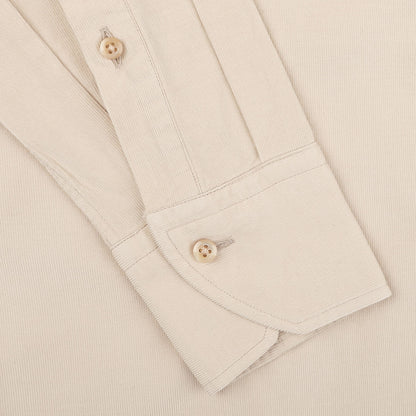 Close-up of a Stenströms Light Beige Cotton Corduroy Slimline Shirt cuff and sleeve, featuring two brown buttons and visible stitching details, showcasing the pure cotton fabric.