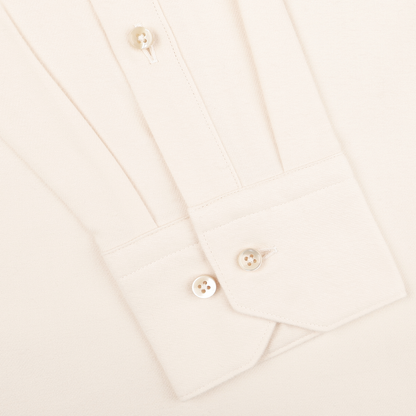 Close-up of the cuff from Stenströms' Off-White Cotton Flannel Fitted Body Shirt, featuring two fastened mother-of-pearl buttons and one visible sleeve button.