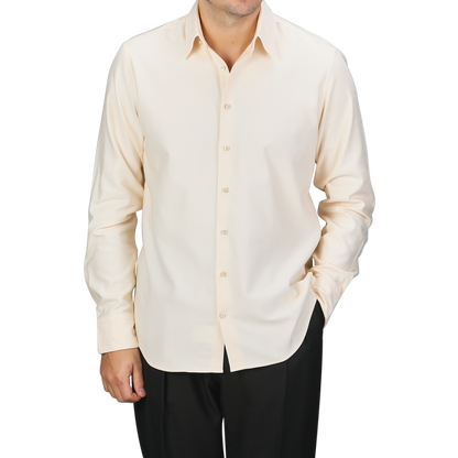 A person wearing a Stenströms Off-White Cotton Flannel Fitted Body Shirt with mother-of-pearl buttons and black pants, with one hand in their pocket.