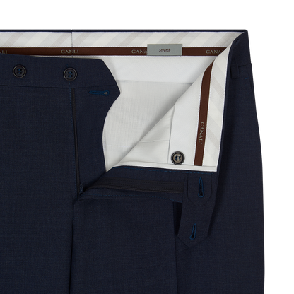 Close-up of the waistband and upper section of Canali Blue Wool Stretch Flat Front Trousers. The open fly reveals white lining with CANALI branding, dark buttons, a Stretch label, and diagonal white stripes on the inner waistband. , available at Richard Gelding Mayfair