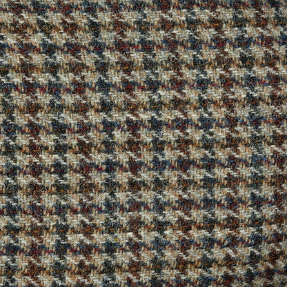A close up of a Beige Houndstooth Harris Tweed Ivy Contemporary Cap, featuring a Wigéns pattern.