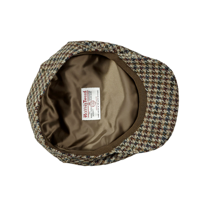 A beige Houndstooth Harris Tweed Ivy Contemporary Cap by Wigéns with a label on it.