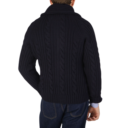 The back view of a man wearing a William Lockie Navy Cable-Knit Lambswool Shawl Collar Cardigan.