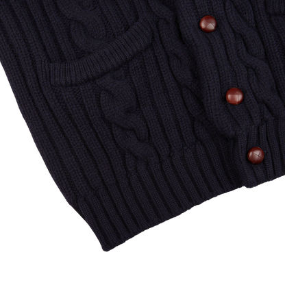 A Navy Cable-Knit Lambswool Shawl Collar Cardigan with buttons on the front manufactured by William Lockie.