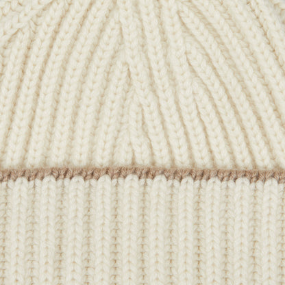 A close up image of a William Lockie White Undyed Cashmere Ribbed Short Beanie.