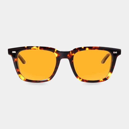 The Carré Eco Dark Havana | Orange sunglasses by TBD Eyewear feature a tortoiseshell frame and bright orange-yellow tinted lenses, shown facing forward on a plain light gray background. , available at Richard Gelding Mayfair