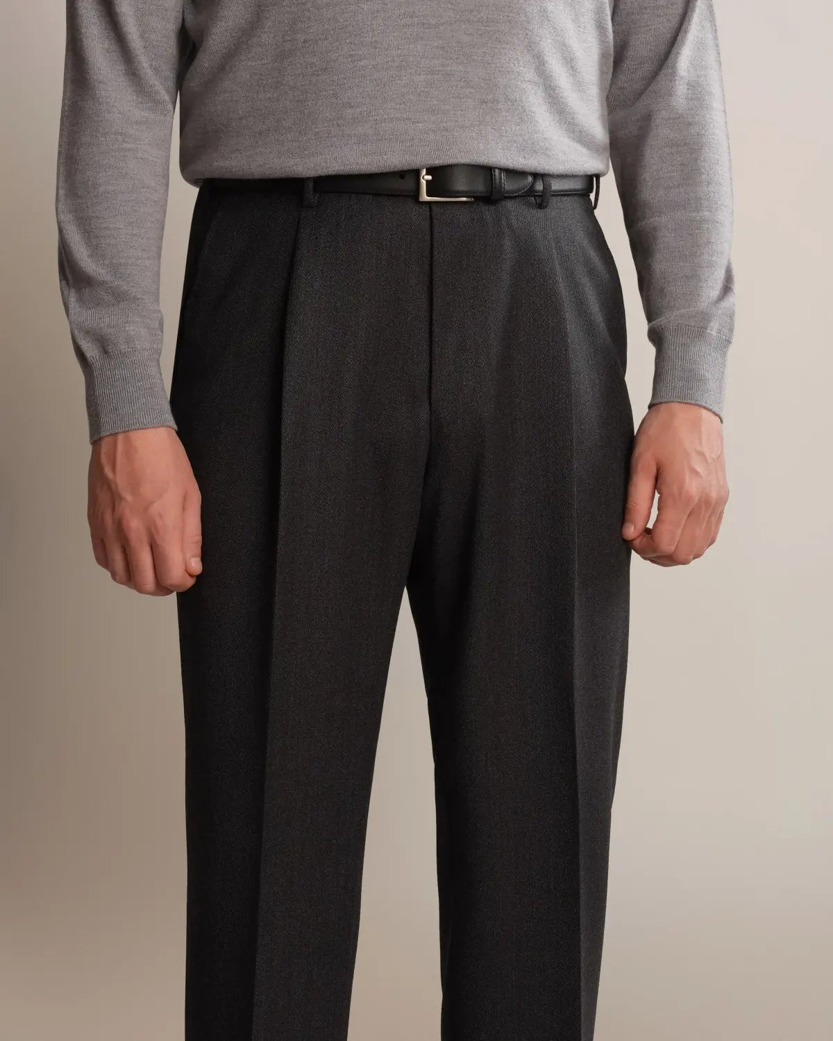 Cavour Charcoal Grey Straight Leg Pleated VBC Covert Wool Trousers in charcoal grey with front pleats and a straight-leg fit, worn with a thin black leather belt and a light grey crewneck sweater against a plain, neutral background. , available at Richard Gelding Mayfair
